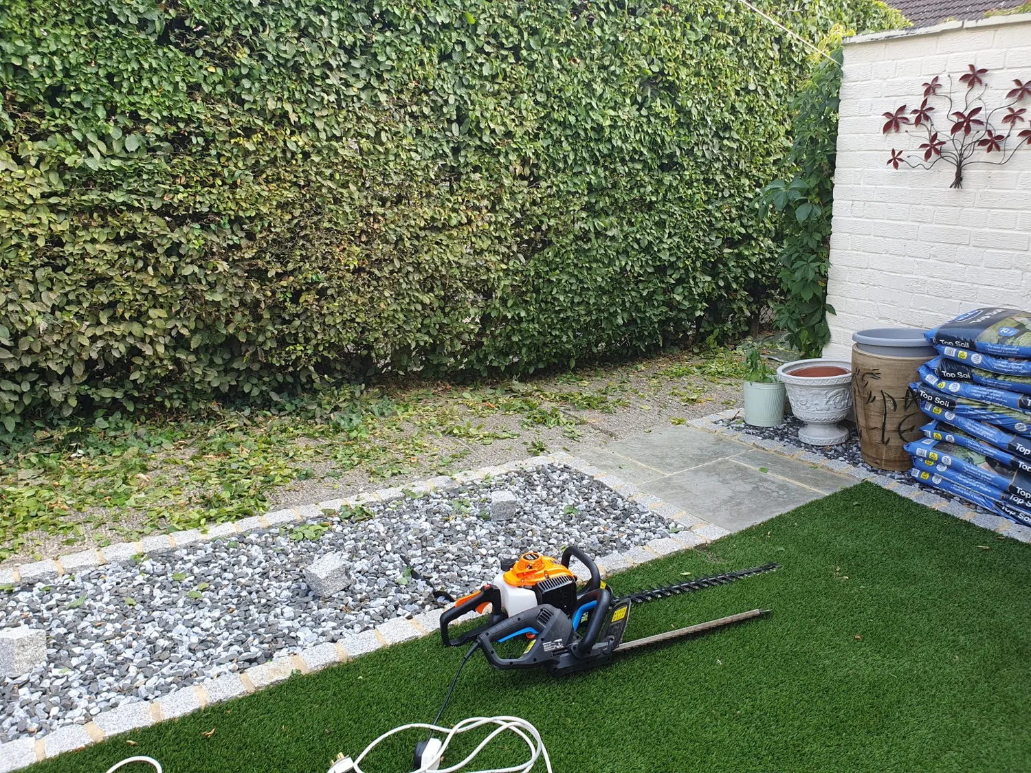 Hedge trimming equipment in a garden